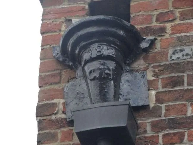 Cast-iron rainwater hopper on the former schoolrooms