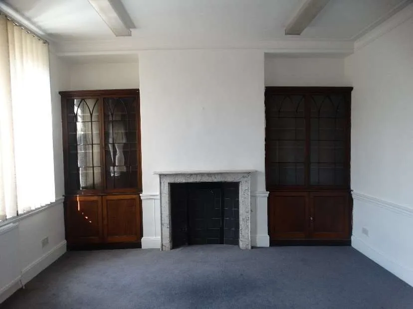 Marble fireplace flanked by late Georgian bookcases