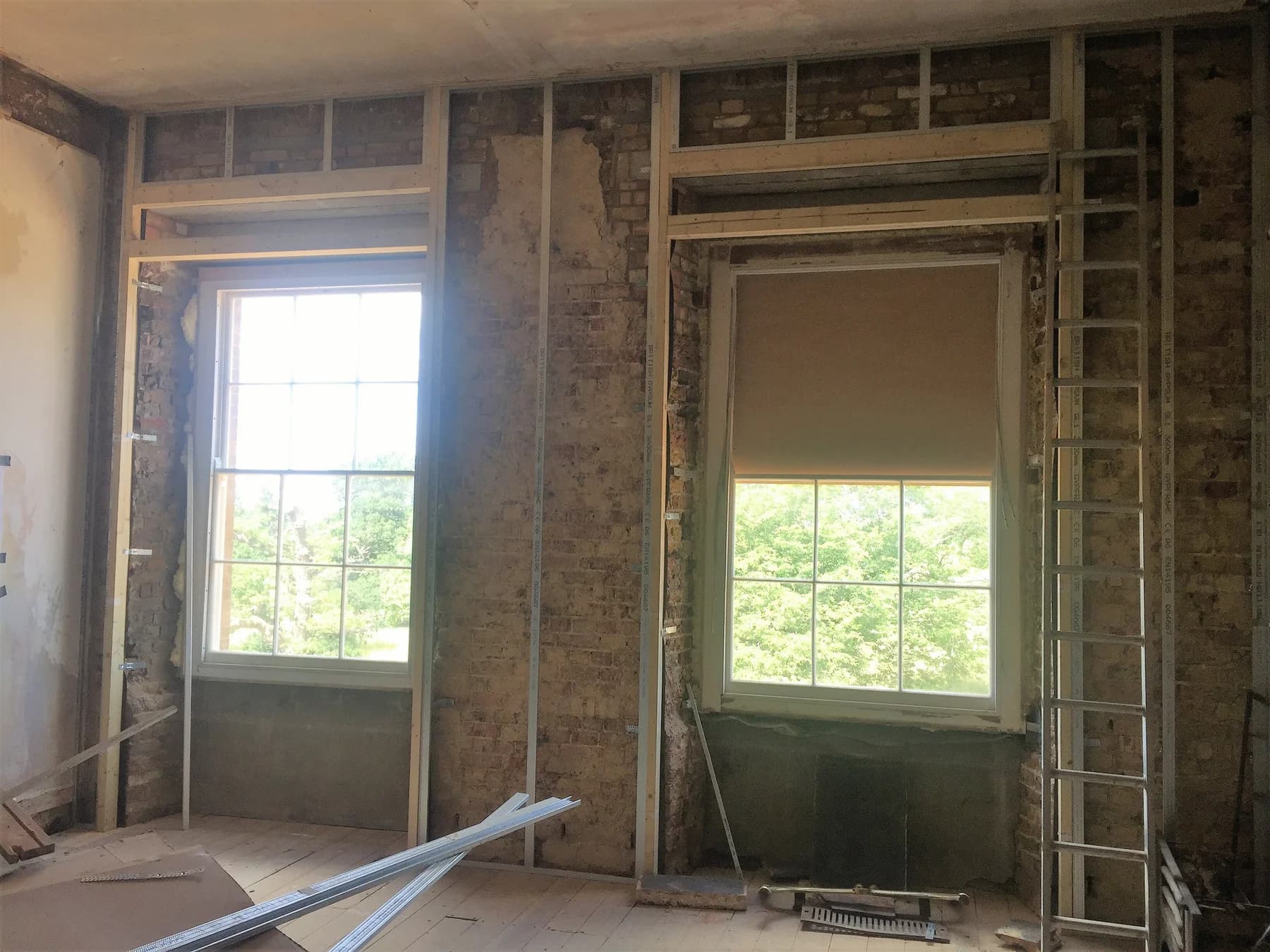 Window openings with exposed timber framing and stripped interior wall surfaces
