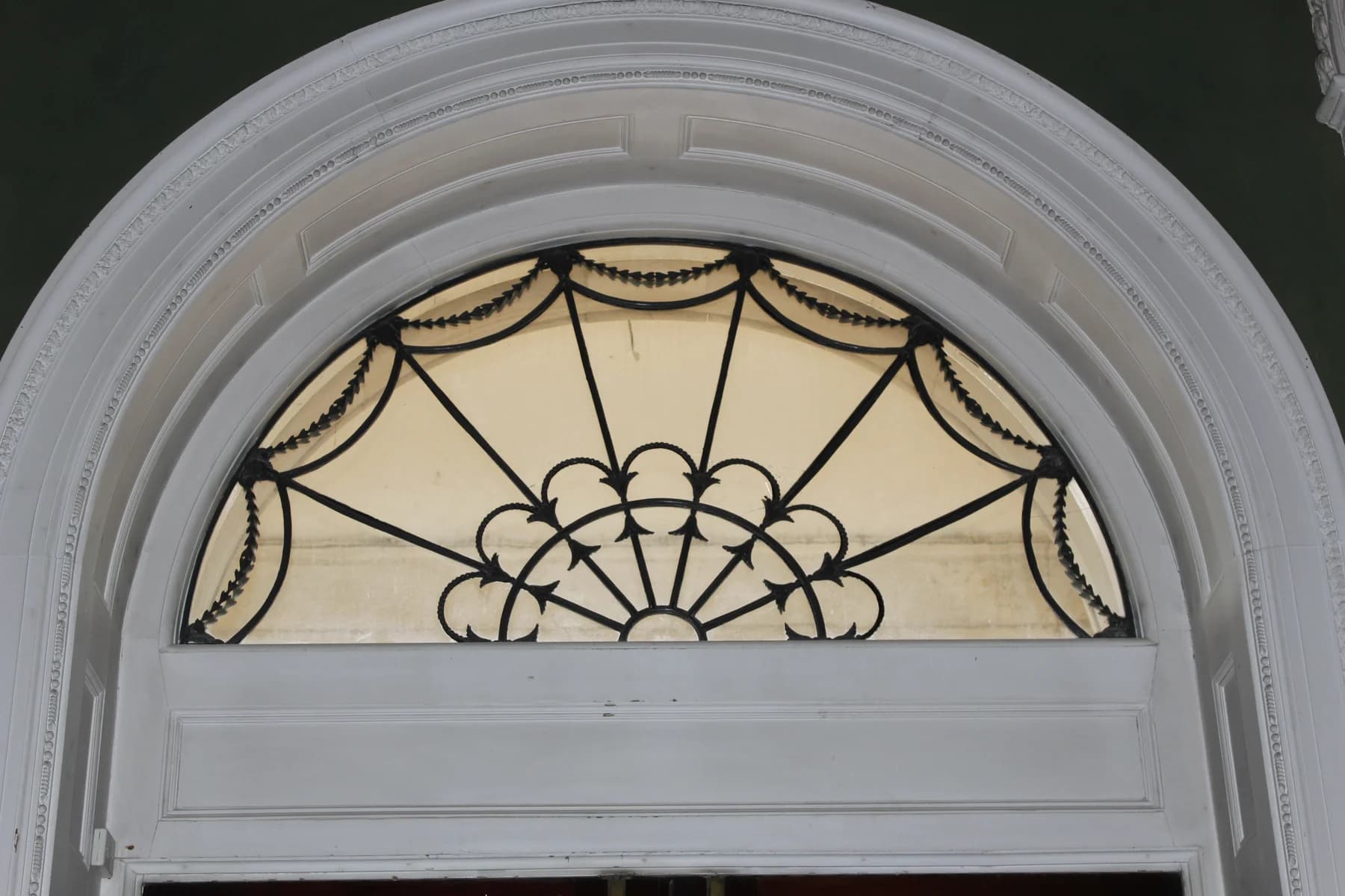 An arched fanlight with radiating decorative glazing bars