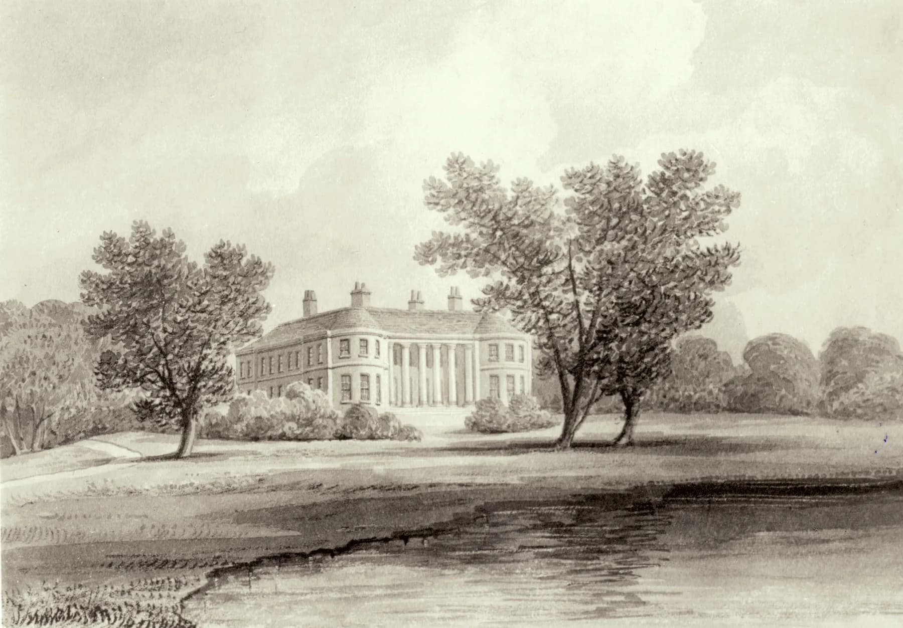 Historic view of Sacombe House beyond an open lawn, framed by trees